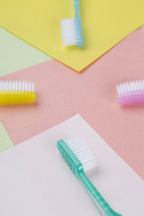 Four toothbrushes on a colourful background.