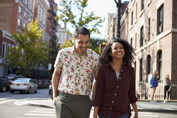 Young Couple Walking Along Urban Street In New York City