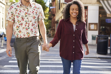Young Couple Crossing Urban Street In New York City