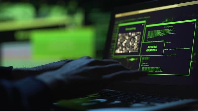Close-up hacker hands working on laptop, selecting password, access granted