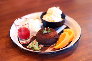 Chocolate fondant lava cake with strawberries sauce, Orange sliced, ice-cream. 
