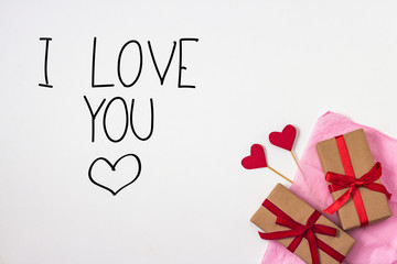 Hearts on Sticks, Two Gifts, Pink Decorative Paper on the White Background. top view. Added text I Love You