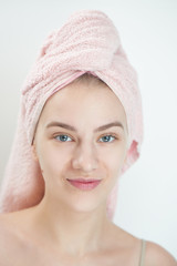 Facials. Young woman with towel on head and clean skin