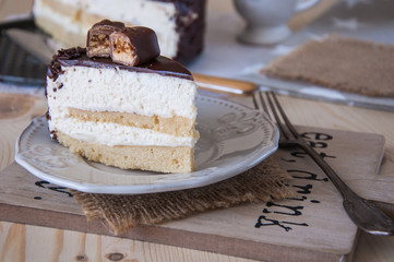 Cake piece Pigeon milk on a wooden background