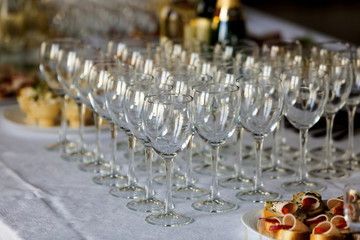wine glasses on a buffet table with appetizers