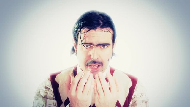 An ugly nerd screaming, his hands are full of blood.

