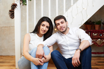 A young family in the apartment decorated for Christmas