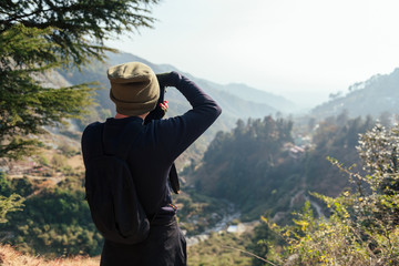 Man take a photo in mountains