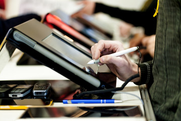hand makes a signature on the tablet