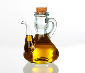Oil bottle with the golden juice of the olive
