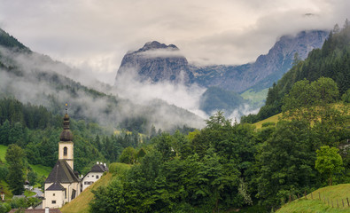 Green alpine valley with fog near Ramsau, Germany