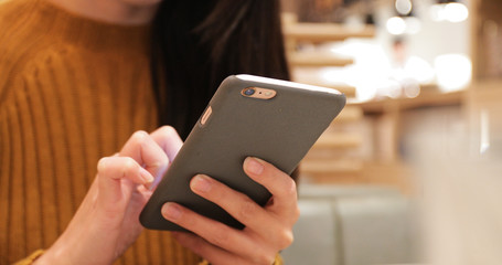 Woman use of mobile phone in restaurant