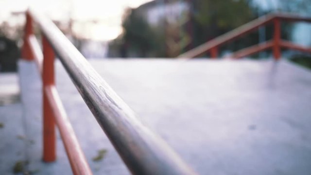 Young man doing trick on scooter in concrete extreme park
