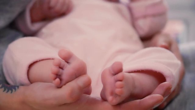 Cute little legs of two-month baby girl