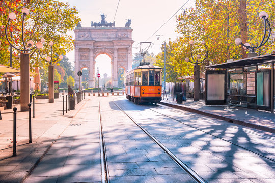 Fototapeta Famous vintage tram in the centre of the Old Town of Milan in the sunny day, Lombardia, Italy. Arch of Peace, or Arco della Pace on the background.