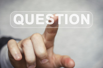 Businessman presses button question virtual digital electronic user interface.