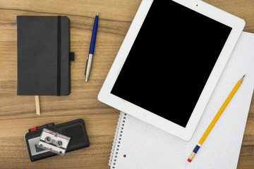 Office table with tablet, notebook and voice recorder
