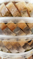 Salted herrings in a plastic pot