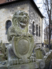 Fototapeta na wymiar Gravestones in Old Jewish Cemetery with Klausen Synagogue, Old Town, Prague, Czech Republic