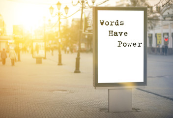 words have power - words, phrase. on a white background billboard in the center of the city against...