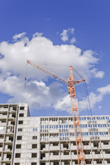 housing construction. crane. new home. blue sky