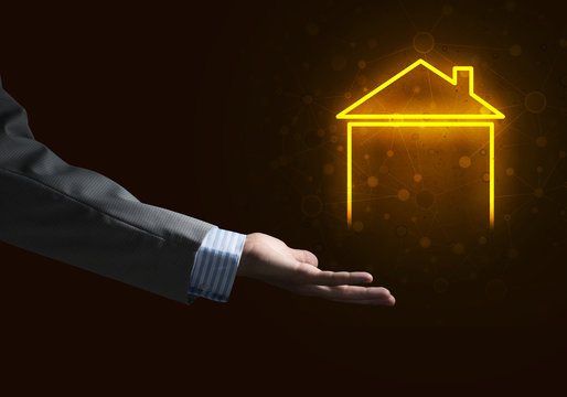 Conceptual image with hand pointing at house or main page icon on dark background