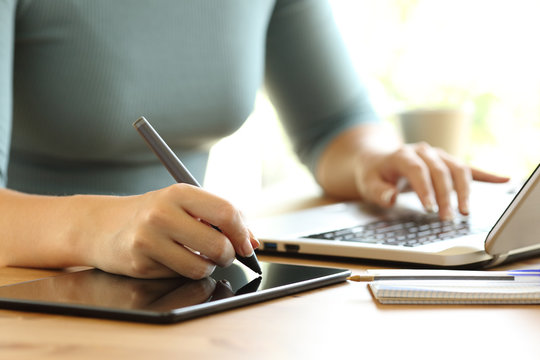 Woman hands working drawing in a digital tablet