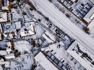 Aerial view of snow covered rail and road networks. Snow, ice and winter weather conditions close...