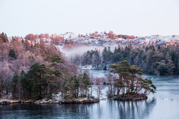 Tarn Hows lake on a frosty morning with slight mist during sunrise