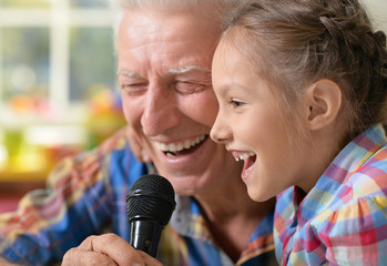  grandfather and child singing karaoke