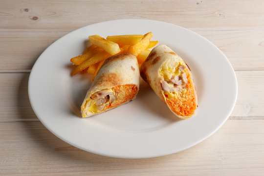 Meat, spicy carrot, cabbage and cheese rolled up in thin pitta bread