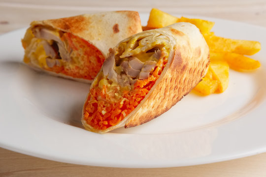 Meat, spicy carrot, cabbage and cheese rolled up in thin pitta bread