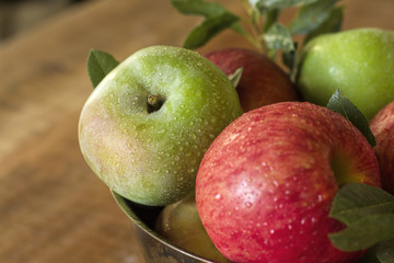 Granny Smith and Honeycrisp apples in a bowl on a wooden table