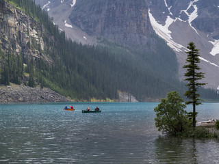 Tourists boating in Moraine Lake, Banff National Park, Alberta, Canada