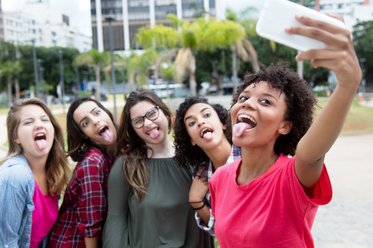 Group of girlfriends taking crazy selfie