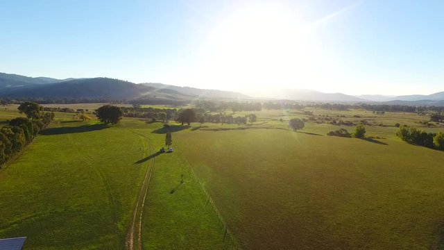 Ascending aerial, sunset over Australia farmland