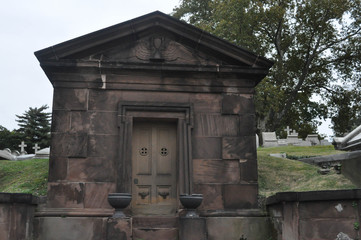 Fototapeta na wymiar Old Stone Mausoleum in a Cemetery