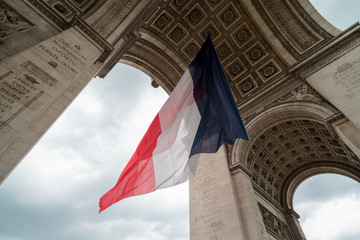 french flag during bastille day in paris at Arc de Triomphe