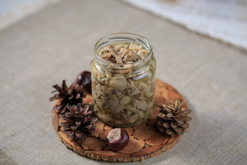 Marinated mushrooms champignons in a steklchnny can on a gray background