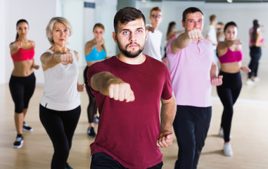happy people posing in fitness studio