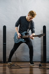 Young man playing electric guitar