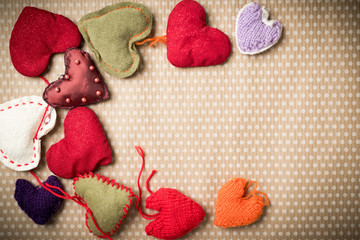 Valentine's Day. Colorful knitted hearts on a vintage background in polka dots. Red heart....