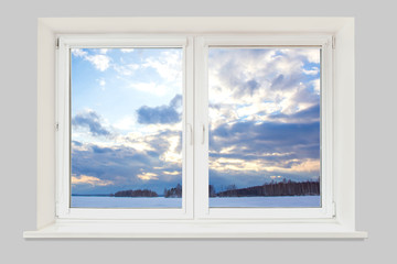 View from the window to the winter landscape with a frozen lake