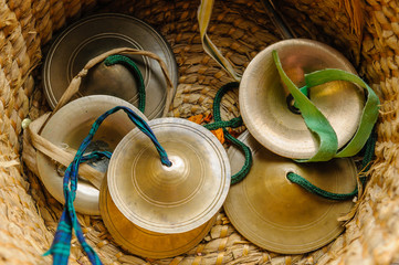 Hare Krishna Kartala hand cymbals in a wicker woven basket