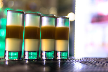 green colour cocktail on short glass bar counter table