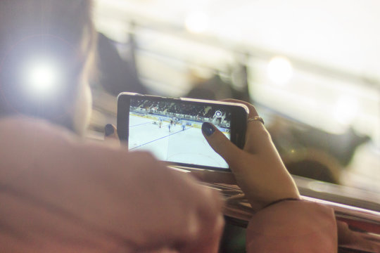 People, Friendship, Sport And Leisure - Happy Friends Watching The Game. Person Takes A Hockey Match By Phone