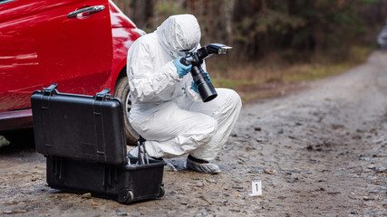 expert collecting evidence at the crime scene. Law and police concept