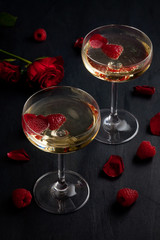 Festive champagne glasses with raspberries