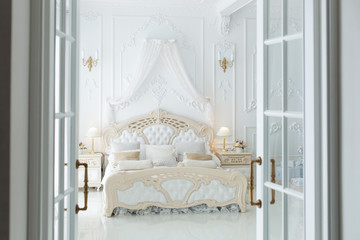 Open door to a beautiful bedroom in the style of rococo.