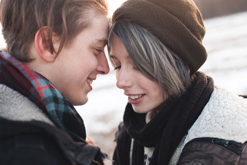 A cheerful young man and woman outdoors. Winter